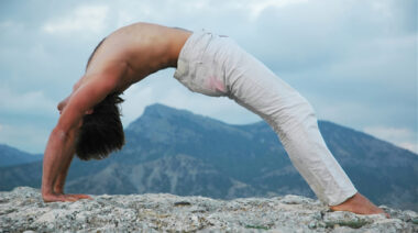 man_doing_a_bridge_on_rock