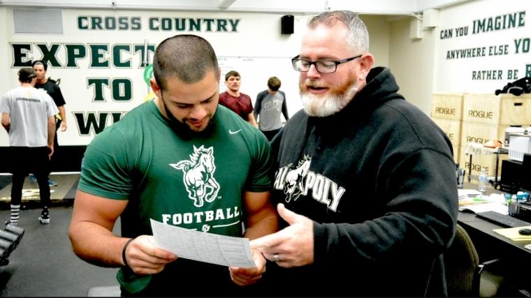 Coach Chris Holder explaining his program to an athlete