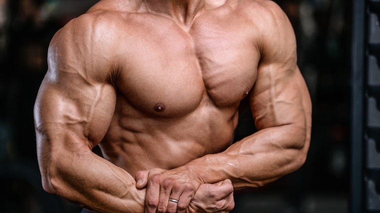 Bodybuilder flexing chest and arm muscles