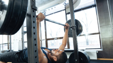 Man performing heavy bench press