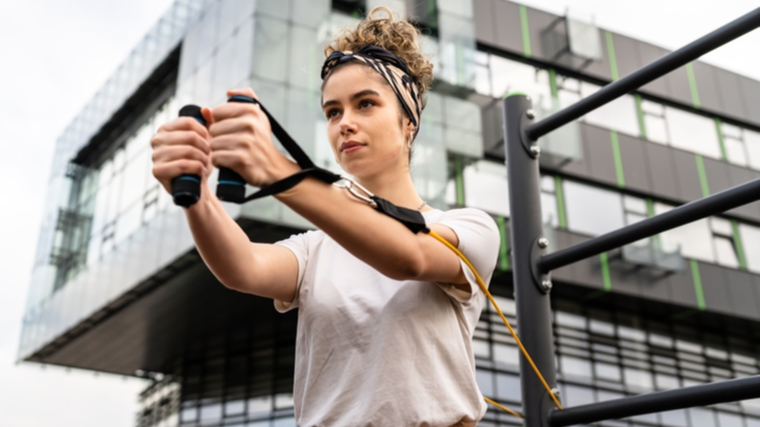 person outdoors exercising with resistance band