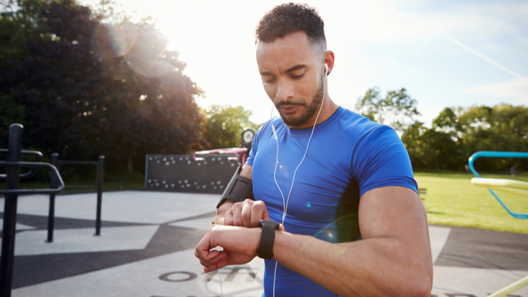 person exercising outdoors checking watch