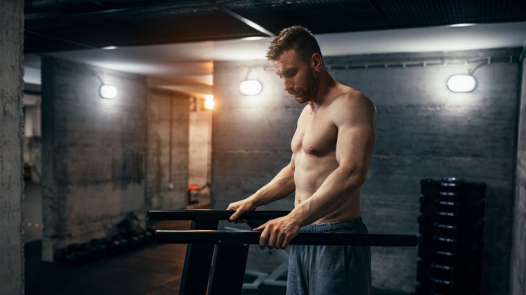 person exercising on parallel bars