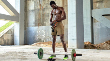 muscular person lifting weights outdoors