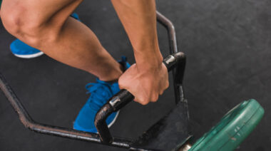 Close-up image of person gripping trap bar handle