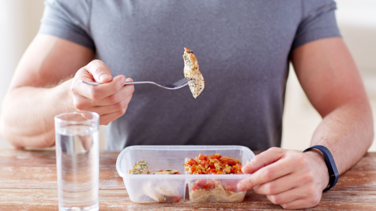 person sitting at table eating food