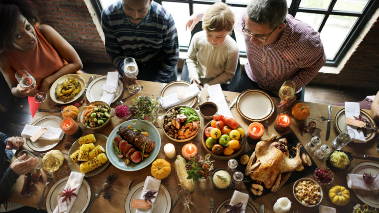 family sitting around holiday dinner table