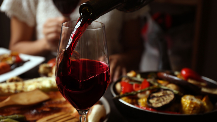 wine poured into glass on dinner table