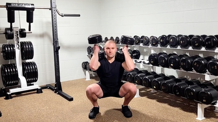 Dr. Merrick Lincoln in gym performing dumbbell squat