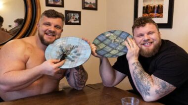 Tom and Luke Stoltman smiling with plates