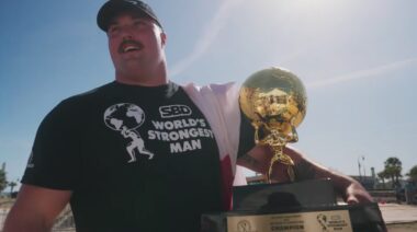 Mitchell Hooper holding 2023 World's Strongest Man trophy