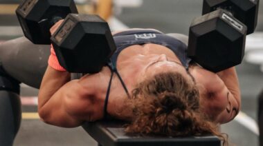 CrossFitter Alex Gazan doing dumbbell bench press