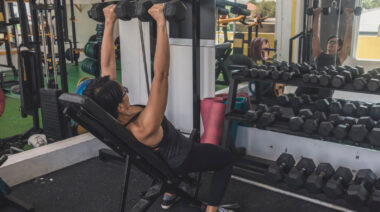 Person in gym doing incline dumbbell press