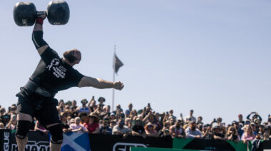 Strongman Oleksii Novikov pressing dumbbell overhead