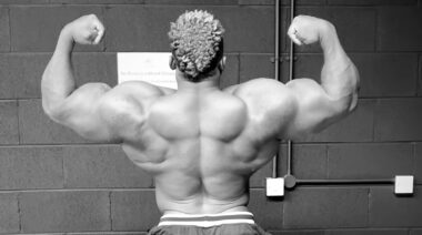 Bodybuilder Blessing Awodibu flexing back and arms