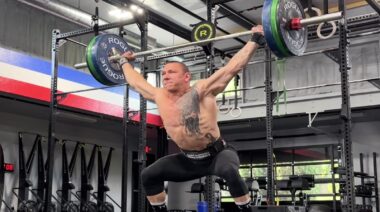 CrossFitter Roman Khrennikov in gym performing barbell snatch