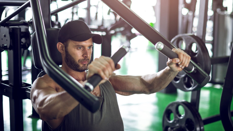 Person in gym using chest press machine