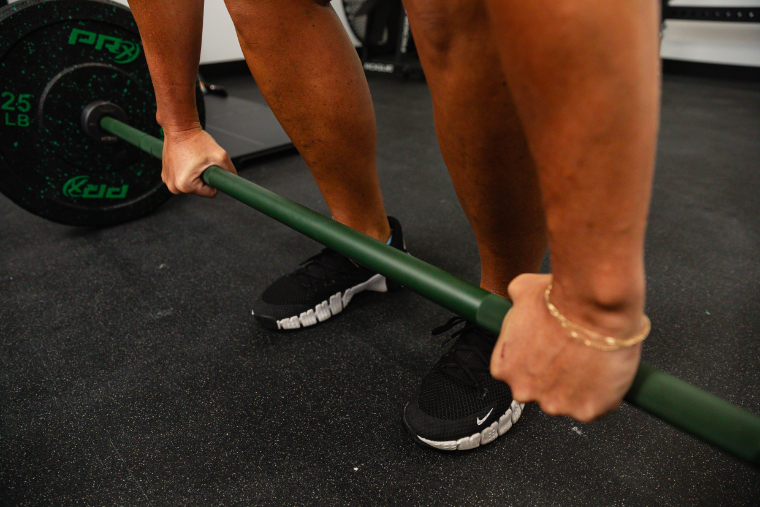 A woman's hands holding the REP Colorado Barbell