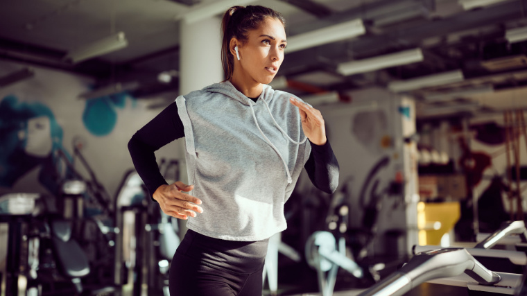 Long-haired person running on treadmill