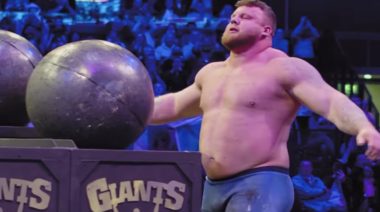 Strongman Tom Stoltman lifting stones in contest