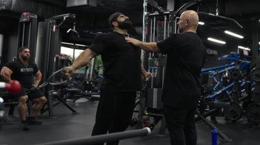 Bodybuilders in gym performing chest workout