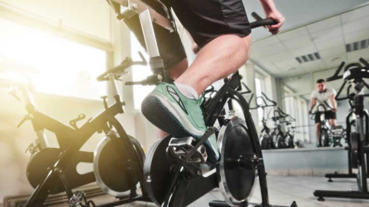 Person in gym using spin bike