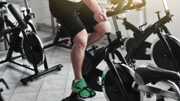 Person in gym on spin bike