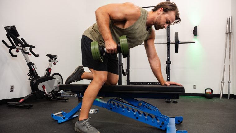 Pulse Beat Fit team member uses the REP Fitness BlackWing Adjustable Bench to perform a row.